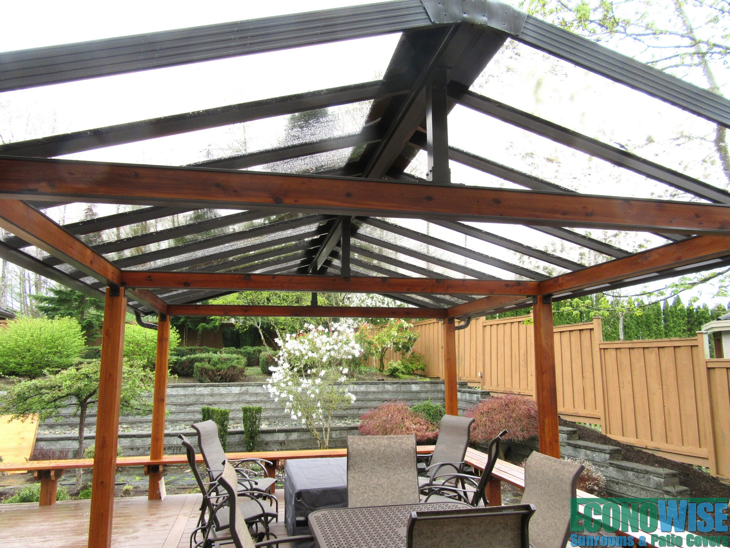 Composite deck with wood benches, and a peaked patio cover with cedar accents